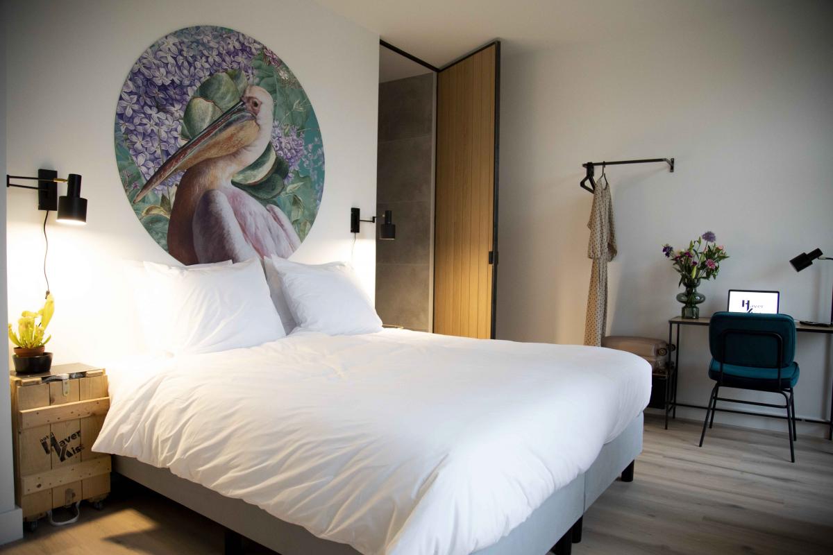 A cozy hotel room in the centre of the city with wooden elements and artsy wall circle